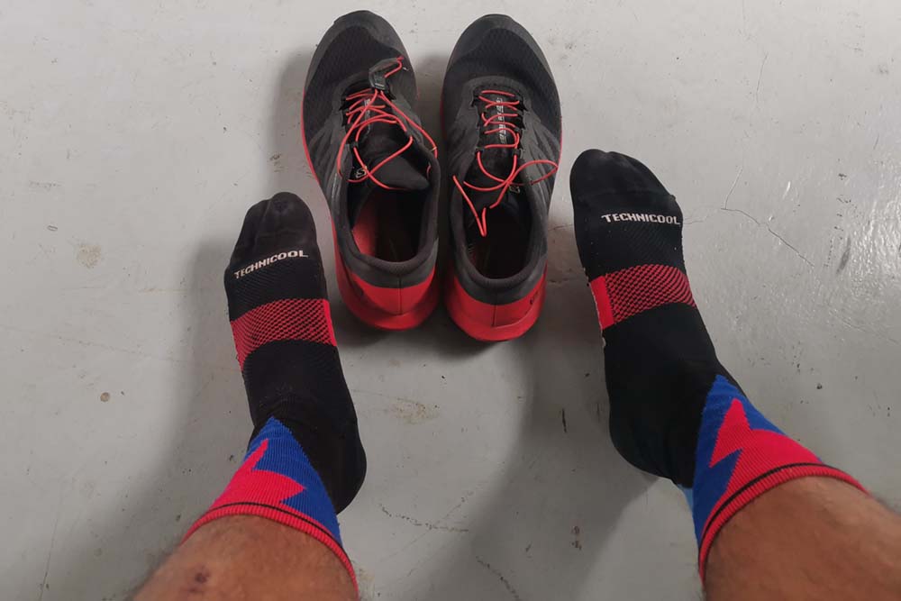 A photo of my feet in running socks getting ready for trail running.